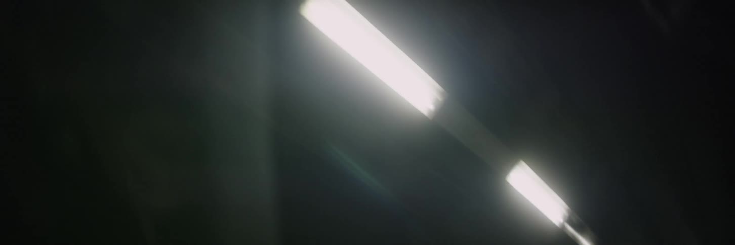 Lights are moving above as they are being passed at night