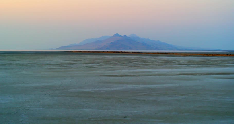 A light layer of snow covers a vast field