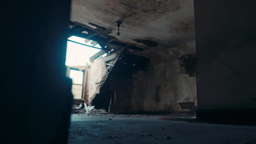 Destroyed room with a window still attached in an abandoned building