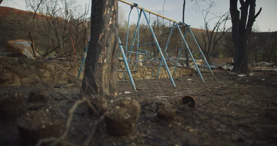 A rusty old swing set sits abandoned