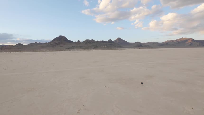A woman walking across the desert