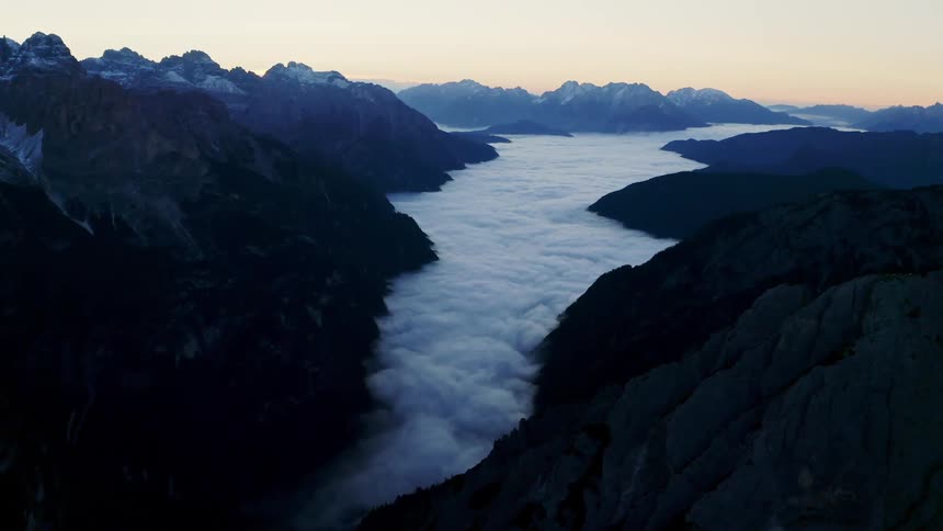 An aerial view of clouds in a mountain range
