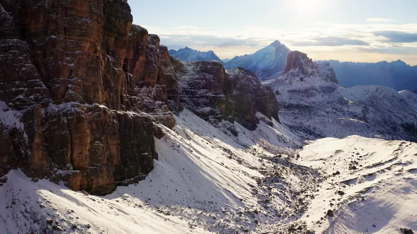 Bushes peak out under a layer of snow on a mountain range