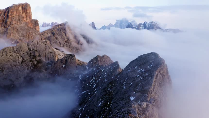 An aerial view of clouds over a mountain range