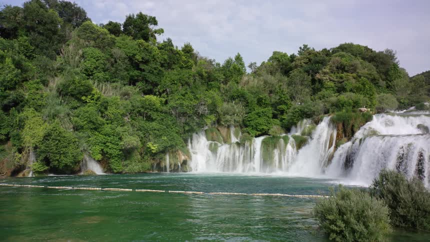 The waterfall falls down in a series of cascades