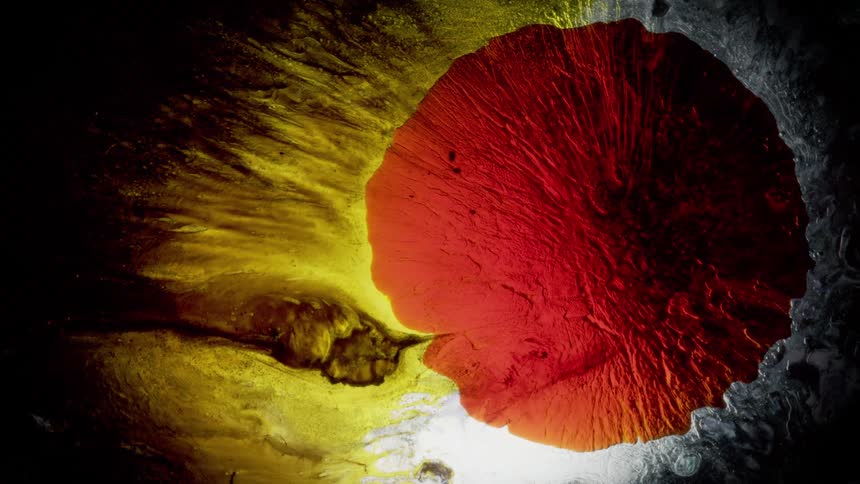 Abstract footage of liquid dye spreading and blending