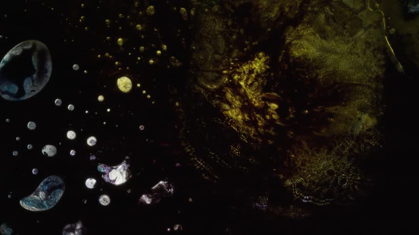 A birds eye view of bubbles in liquid moving as it mixes with water