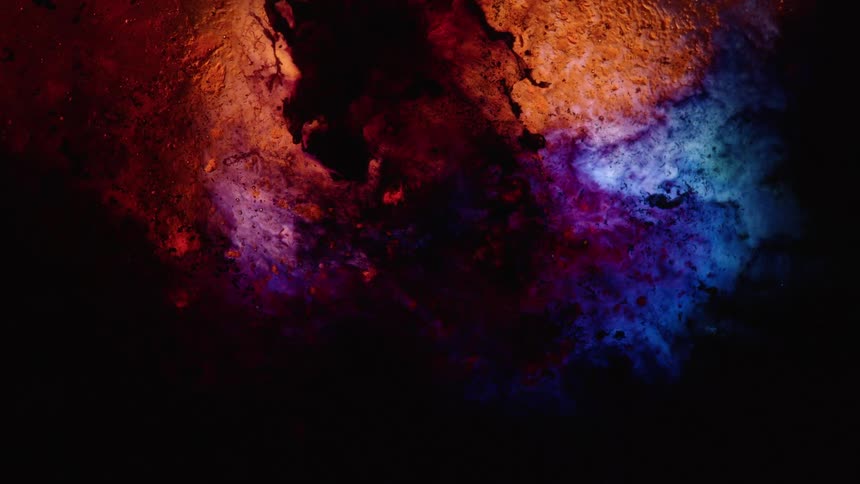Amber and blueish liquids moving upwards through a liquid