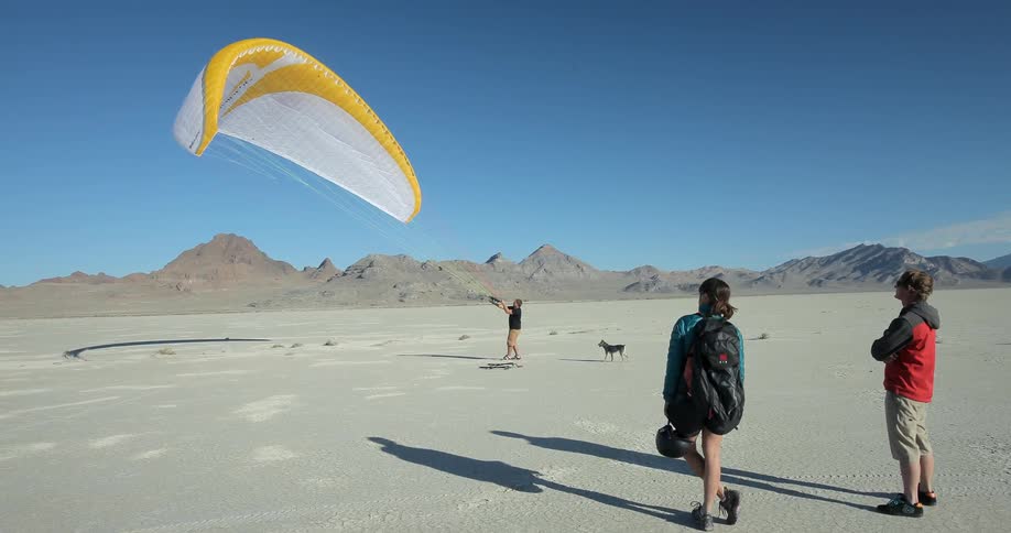 Man pulling and lifting a parasail up into the air