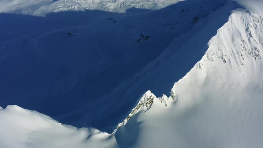 Snowy mountain slopes and summits on a sunny day