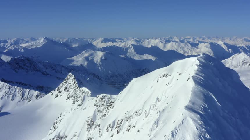 Sun shines over mountains covered with snow