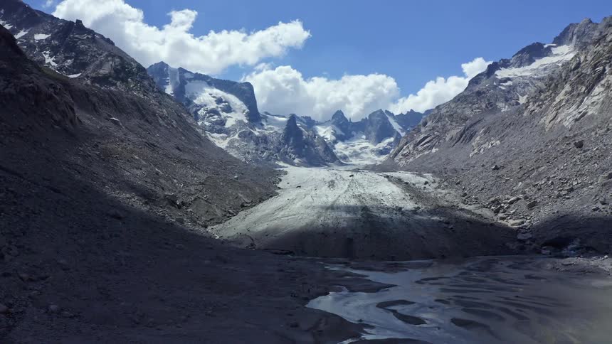 Mountains with a road through the middle with blue skies and some clouds