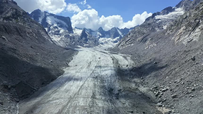 Cleared ground for a road in the mountains with blue sky at daytime