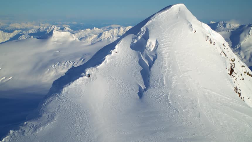 Snow covered mountains on a sunny day against a very blue sky