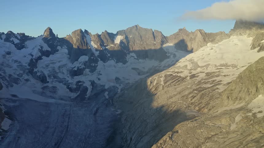 A view of mountains that have snow on them from the air