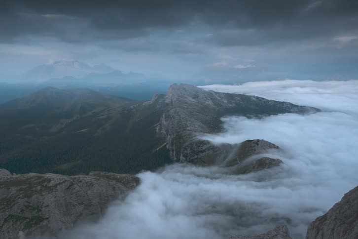 Clouds rolling over a mountain in a timelapse