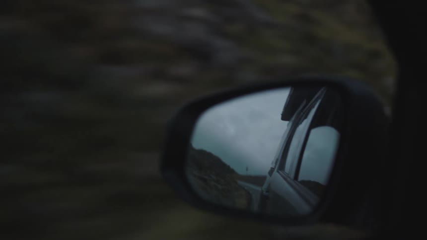 The side mirror on a car as it drives
