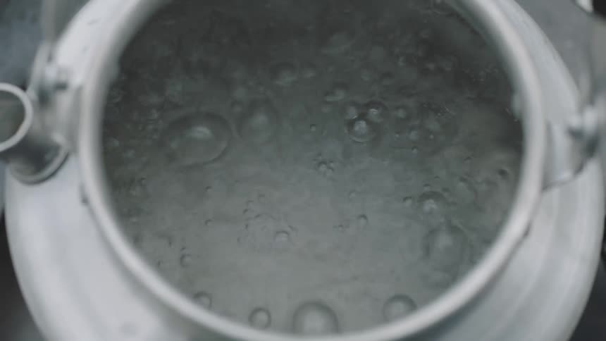 Water is boiling in a metal container