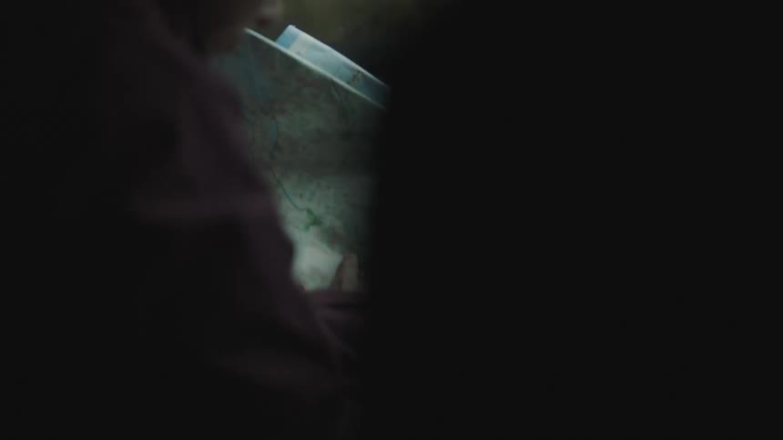 Woman sitting in the passenger seat of a car looking at a map