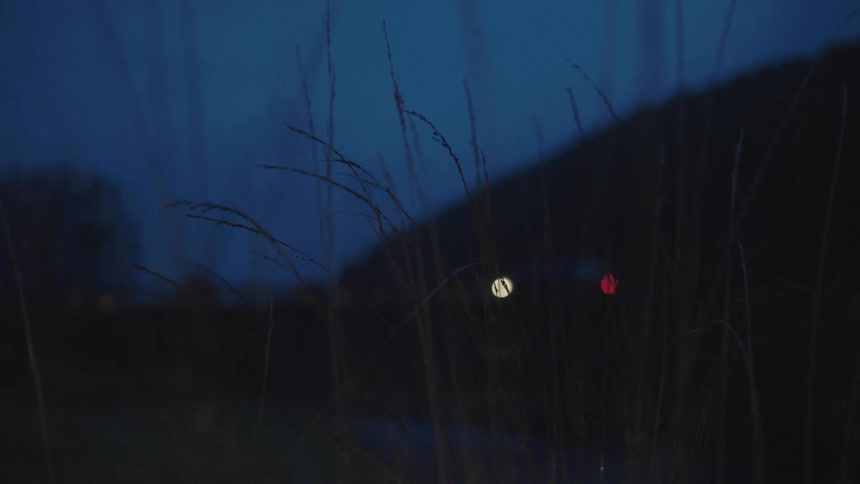 A car driving past a hill