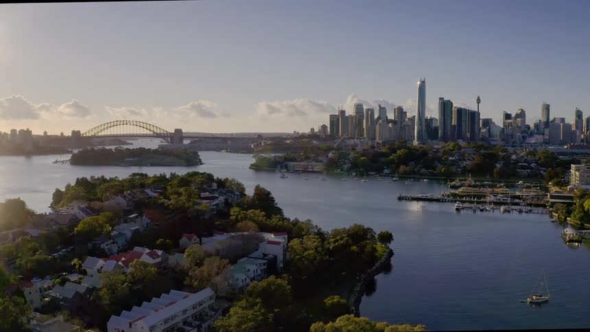 A metropolitan area packed with tall buildings is located along the coastline