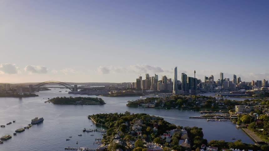 An aerial view of a city with surrounding water bridge and boats in the water