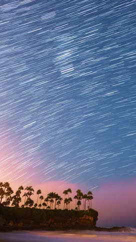 Heavy fog covers the stars in the sky over a beach