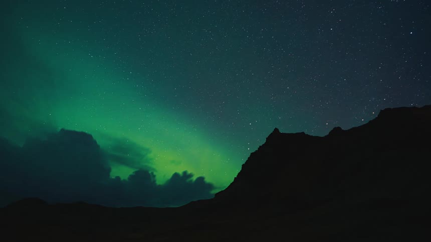 Rolling clouds in the night over mountains