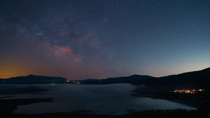 Stars light up the night sky over a coastal neighborhood