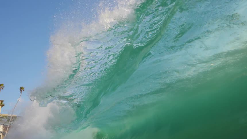 A wave crashing upon more water