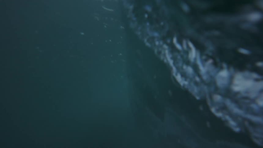 Large ocean waves at day time off the coast of a beach folding over themselves