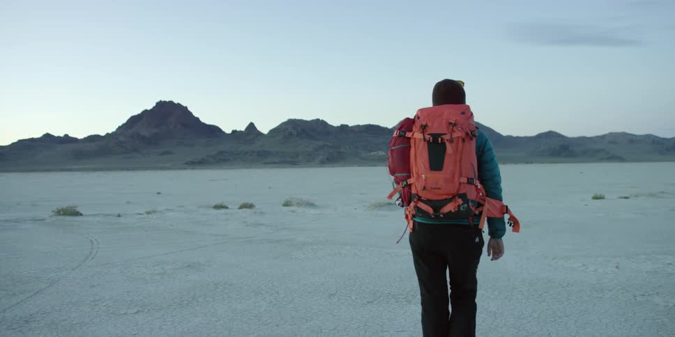 A person is hiking over a desert area