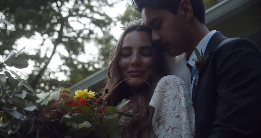 A man and woman hold one another and hug at their wedding