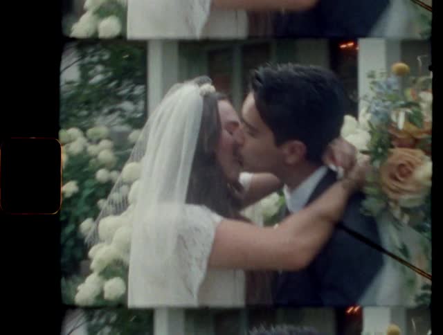 A wedding couple kissing and hugging outdoors