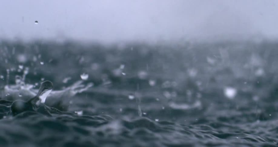 Countless raindrops plunge into the ocean surface during a severe storm