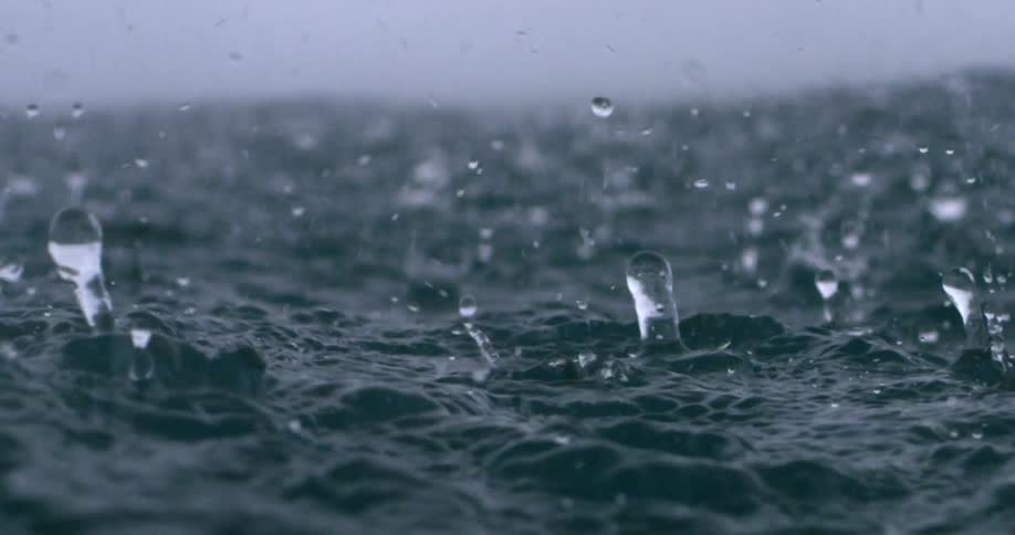Torrents of rain splash into the surface of the ocean during a strorm
