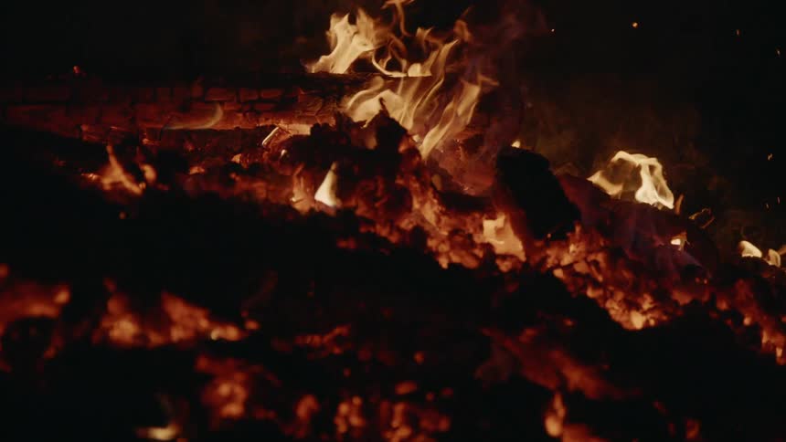 Flames and fire with embers and wood burning