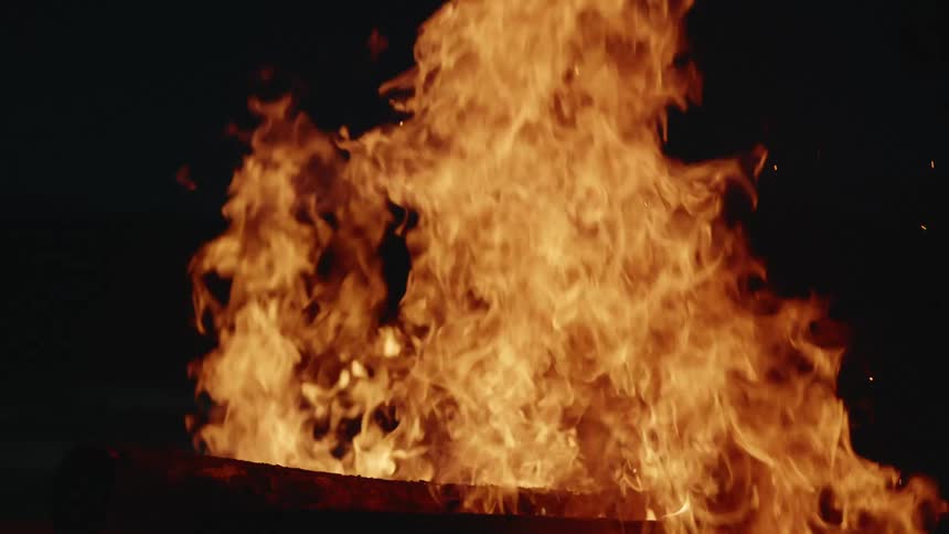 Large fire burning upwards in a dark area