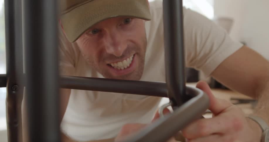 A man assembles furniture indoors