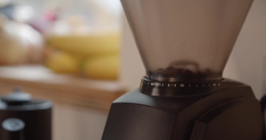 Coffee beans in a grinder in a home