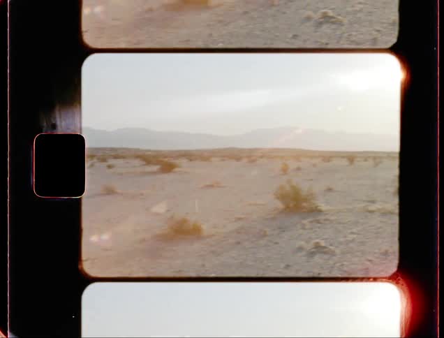 A woman walks through the desert on the film