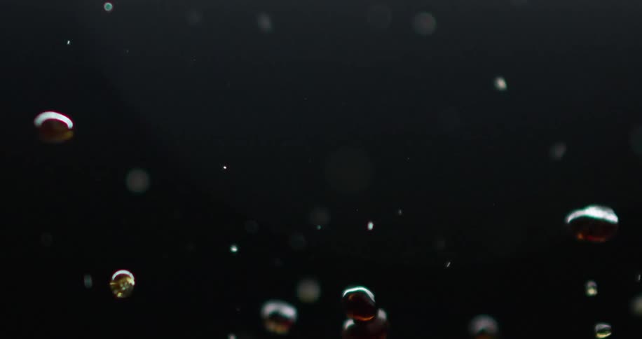 Brown liquid droplets splashing around