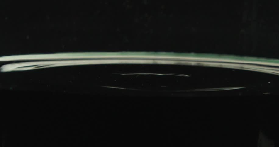 A droplet of water falling in to liquid