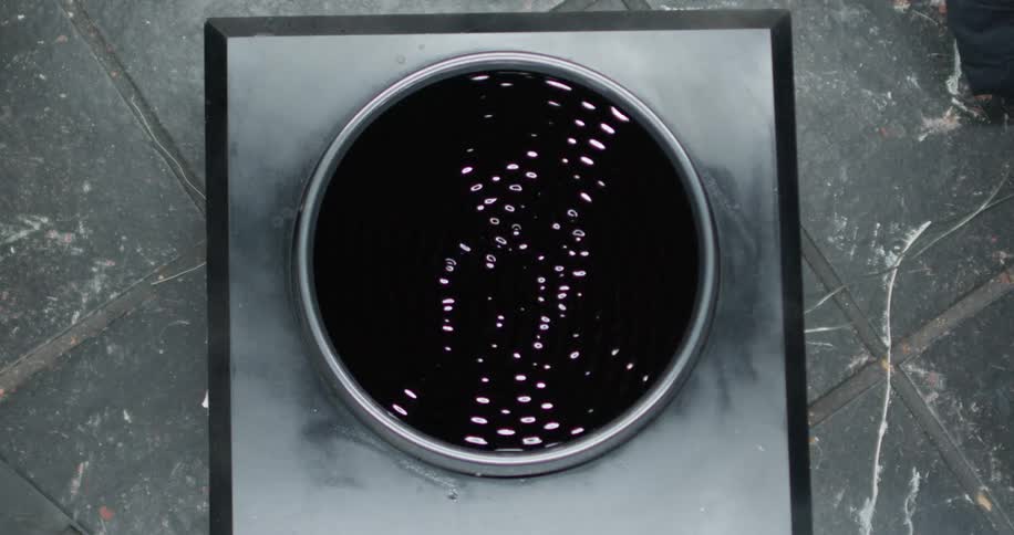 Water spins faster and faster in a centrifuge placed on a gray marble floor