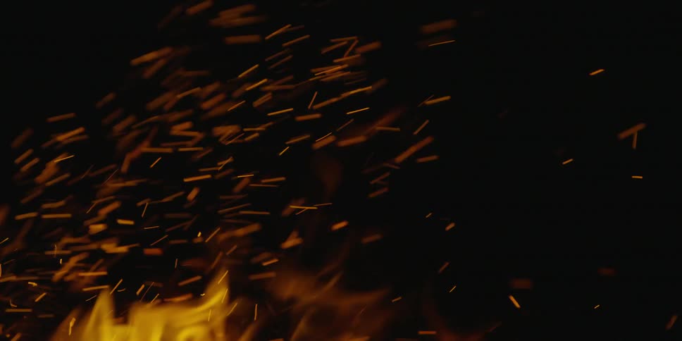 Flames of a small fire burning in the darkness