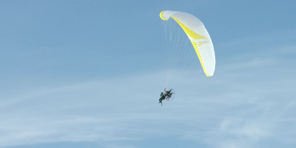 A person parasailing on a clear day