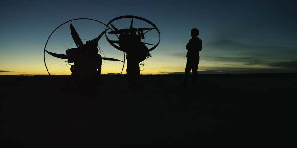 People pick up giant fans after sunset