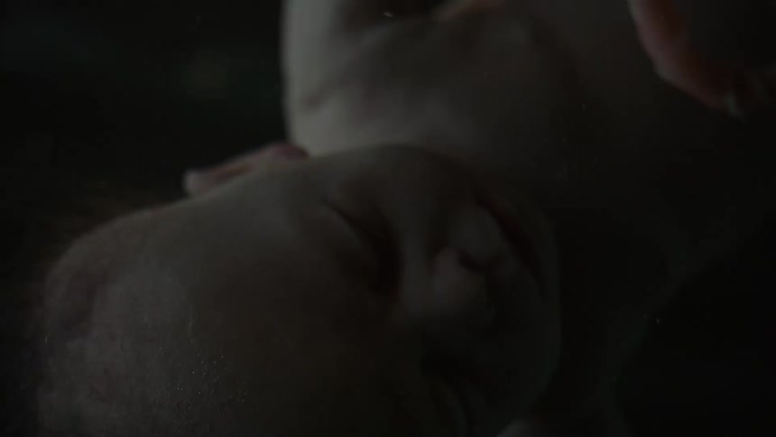 Light brightens baby slowly turning in fluid