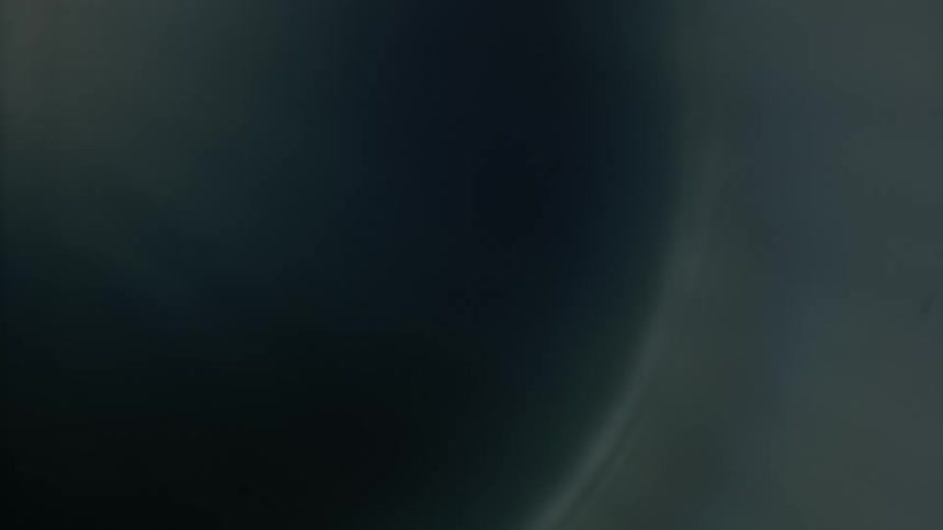 A gray orb grows as lights shines and glows