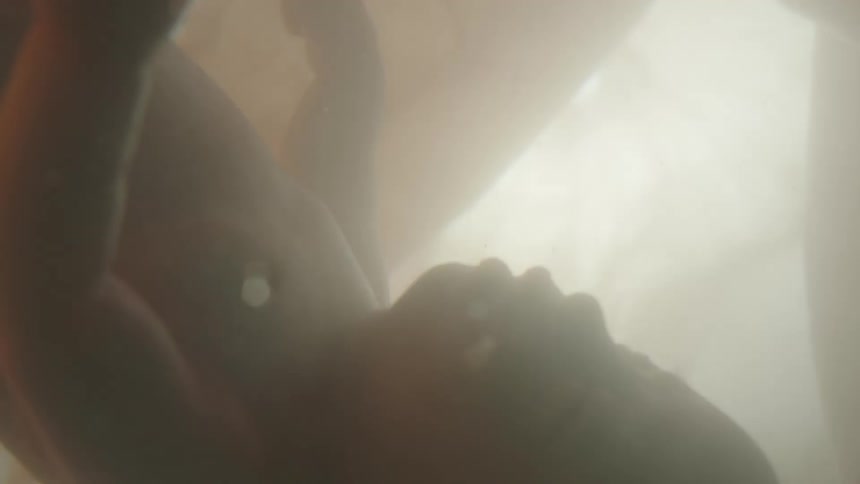 Unborn baby with the umbilical cord in the womb